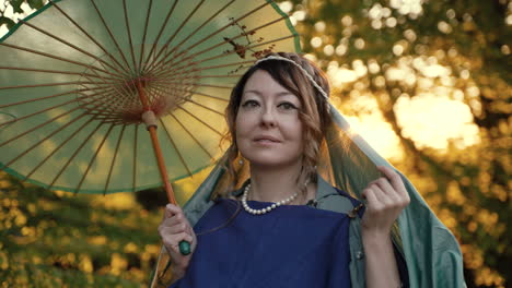 smiling woman in historical costume with japanese umbrella