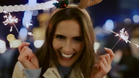 video of  attractive woman with sparklers on christmas marke