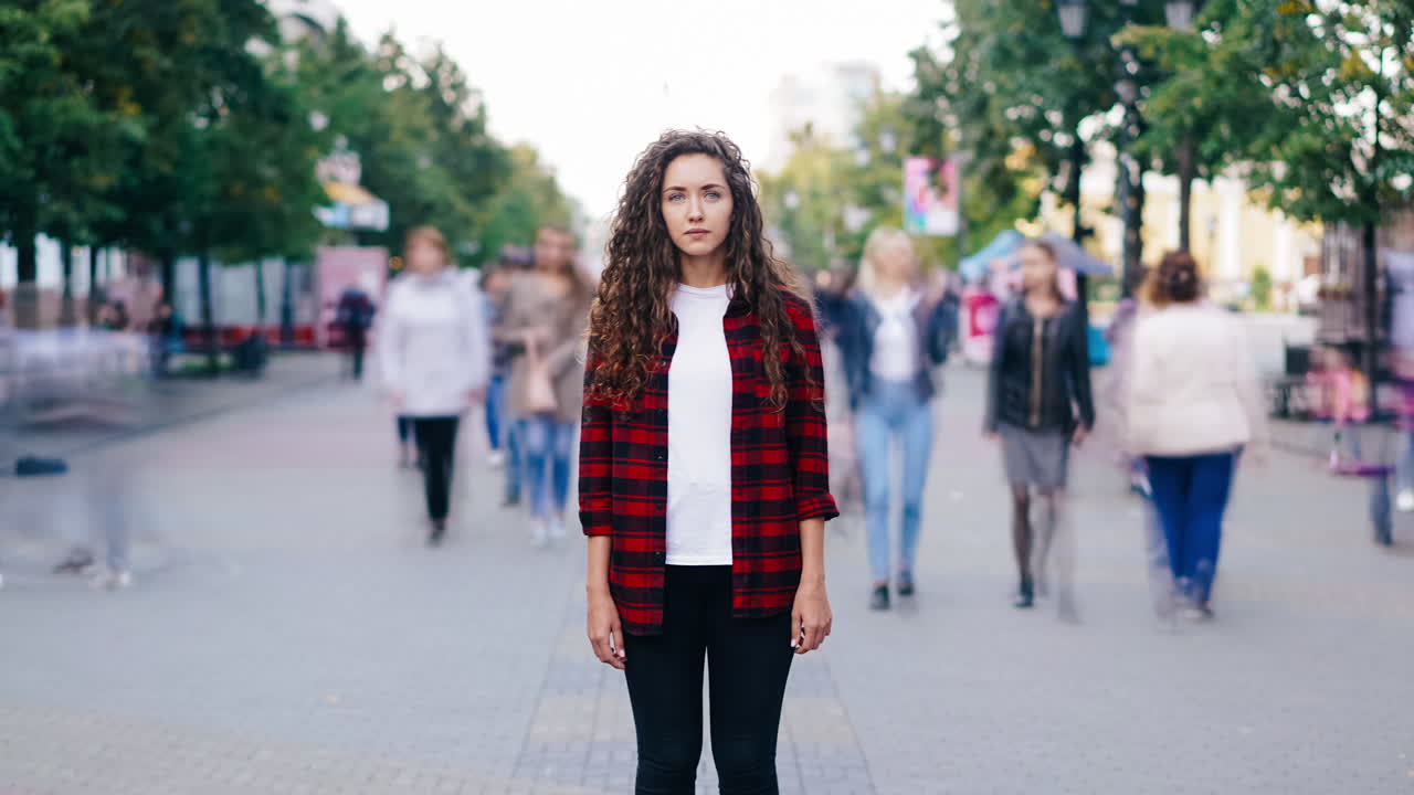 Woman in a red plaid shirt on a city street
