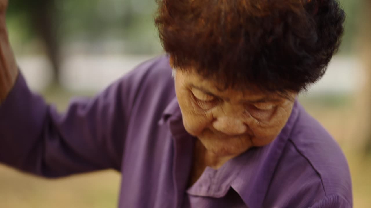 Close-up of an elderly person working outdoors