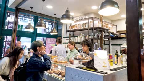 customers interacting and ordering in a bustling cafe