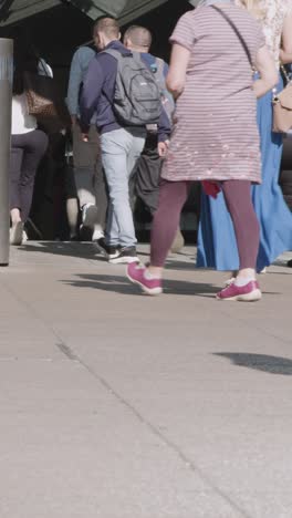 Vertical-Video-Close-Up-Of-London-Commuters-Walking-Escalator-Train-Or-Tube-UK