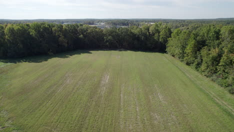 Aerial-Drone-reveals-Rock-Quarry-behind-grass-field