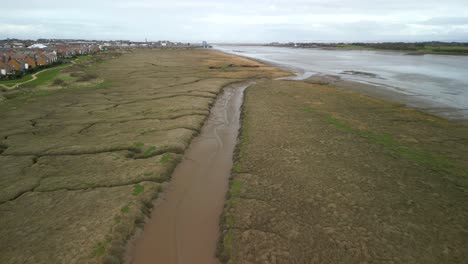 Salt-marsh-tributary-with-distant-shipwrecks-at-Fleetwood-Marshes-Nature-Reserve