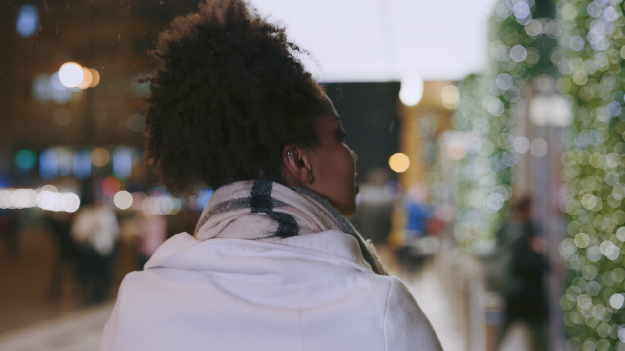 A woman walking in the city at night