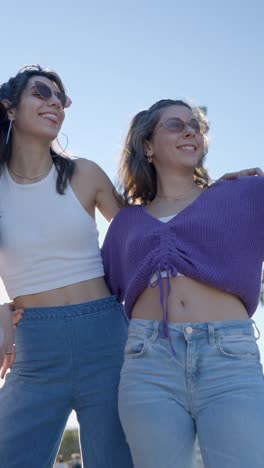 three young women friends enjoying a sunny day outdoors