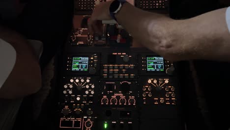 cockpit inside view while copilot is starting-up left engine in a modern medium size jet