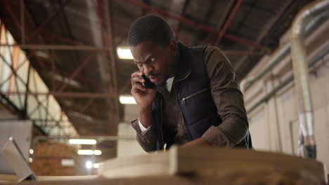 man talking on phone in warehouse
