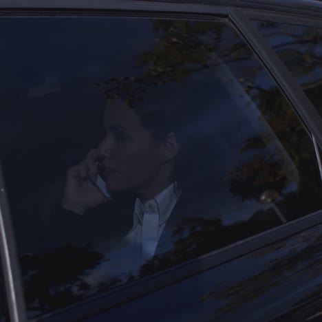 Serious-young-executive-on-phone-in-limousine