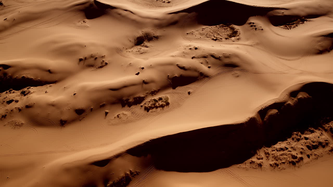 Aerial shot looking straight down on the mesmerizing patterns of Southern Utah’s pink sand dunes.