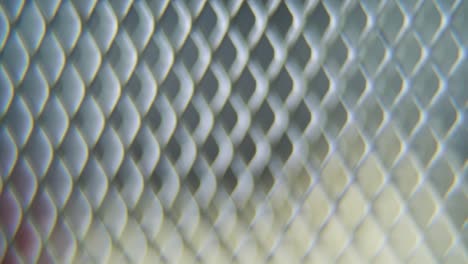 A-hyper-macro-shot-of-a-metal-grid,-steel-pattern,-iron-industrial-texture,-aluminum-material,-super-slow-motion,-Full-HD-120-fps,-smooth-crane-movement,-blurry-Depth-Of-Field