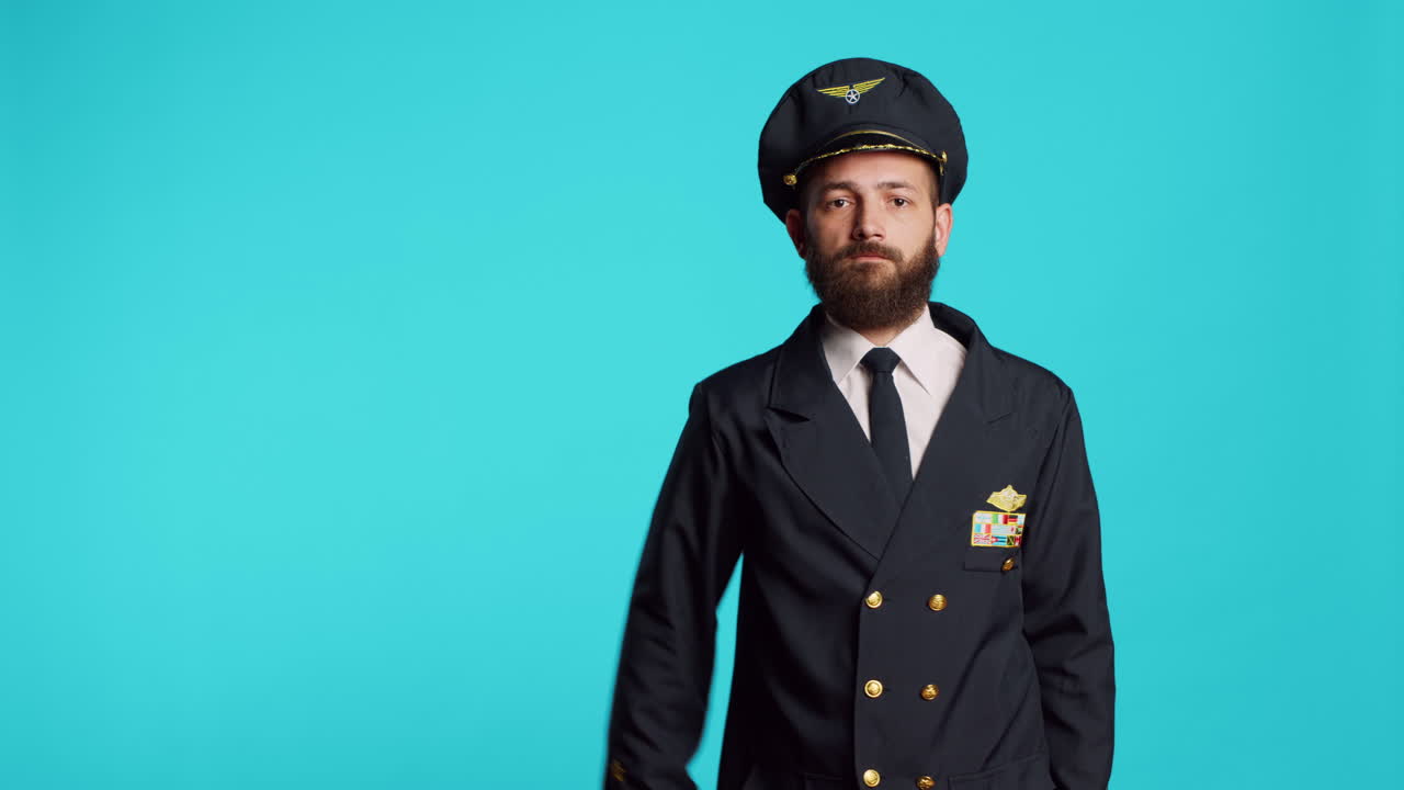 Young pilot showing military salute in studio