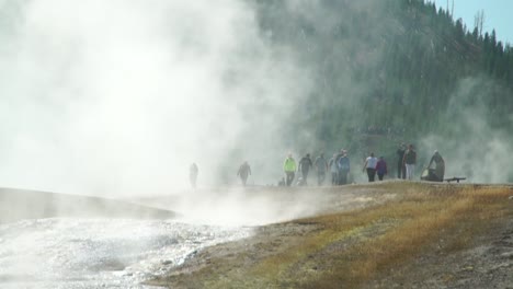 Besucher-Der-Herrlichen-Prismatischen-Heißen-Quellen-Im-Yellowstone-Nationalpark-Werden-Von-Dampfenden-Nebeln-Verdeckt,-Die-Aus-Den-überhitzten-Teichen-Aufsteigen