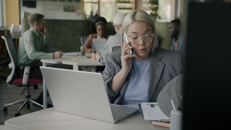 businesswoman on phone call in busy office