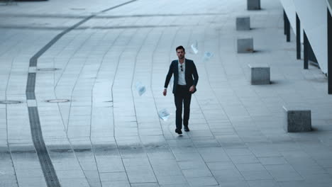 Businessman-reading-documents-at-street.-Man-throwing-papers-in-slow-motion
