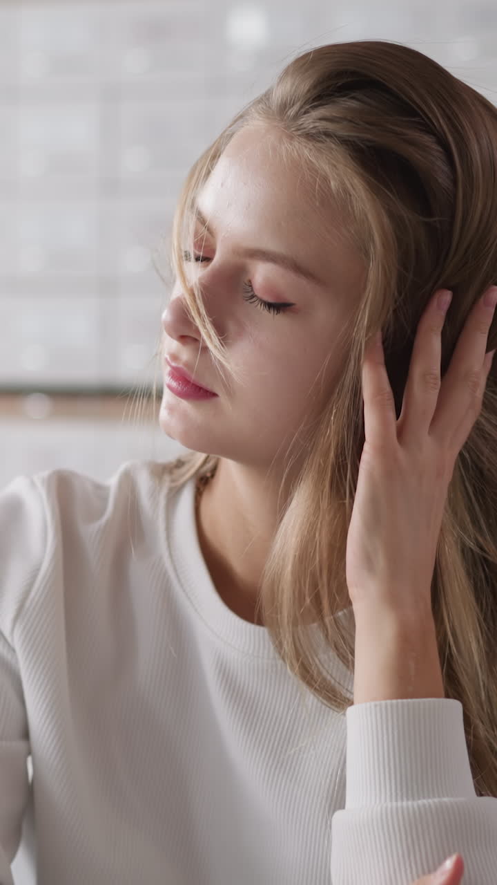 Blonde woman fixes loose hair against card index cases. Student tired of learning closes eyes sitting at table in university library. Overwork during preparation
