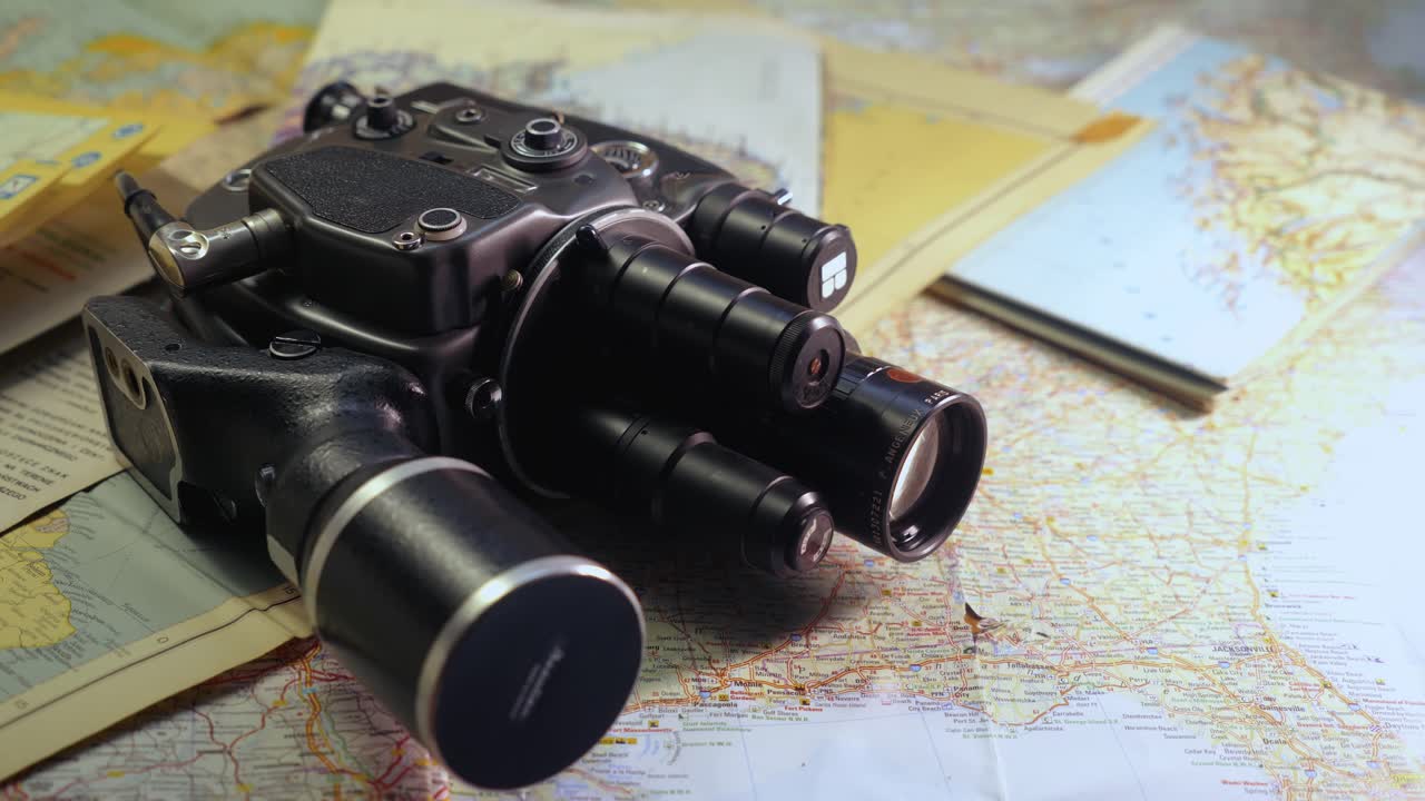 Vintage 8mm cine camera with road travel maps evoke nostalgic journeys