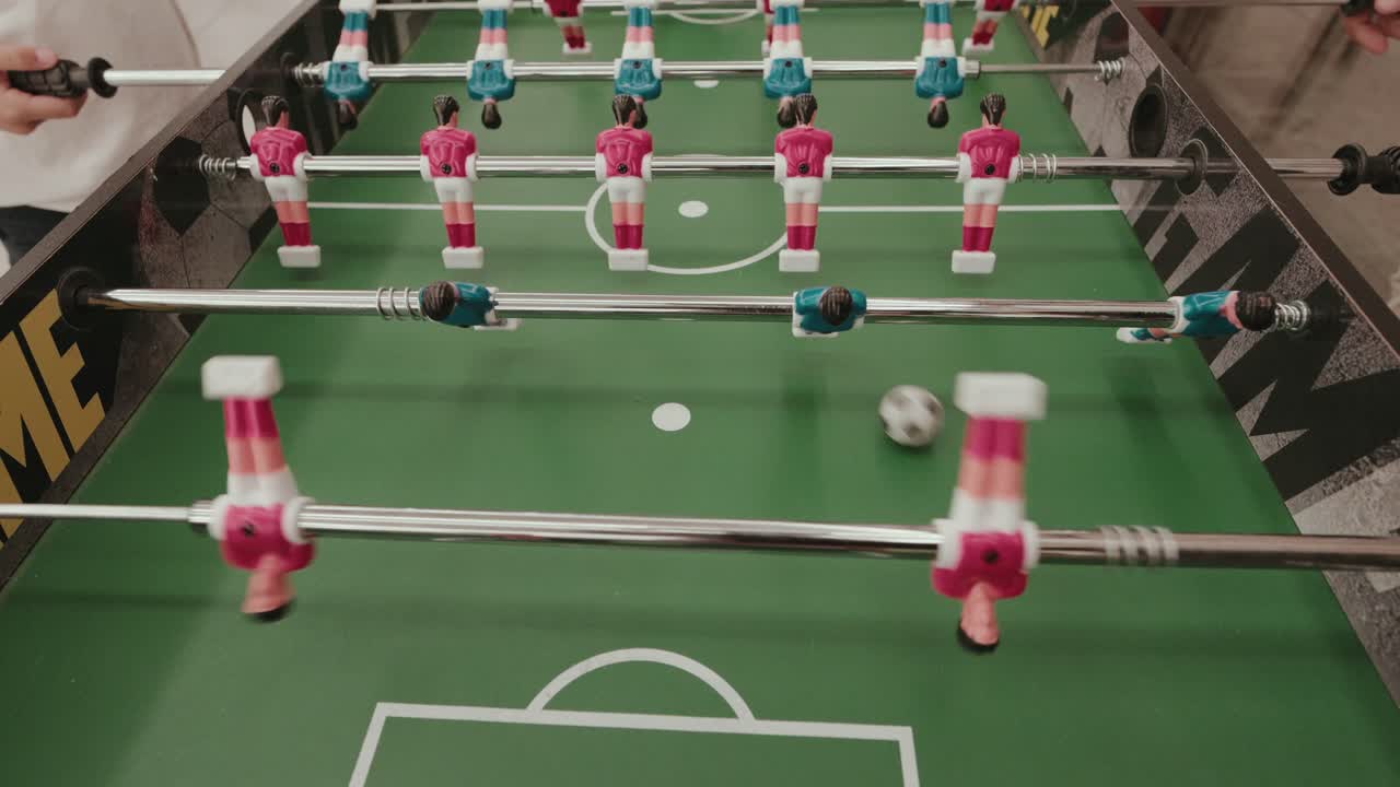 Closeup of foosball soccer game with players moving on table