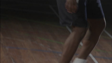 three men play basketball on an indoor court