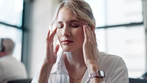 businesswoman experiencing headache in office