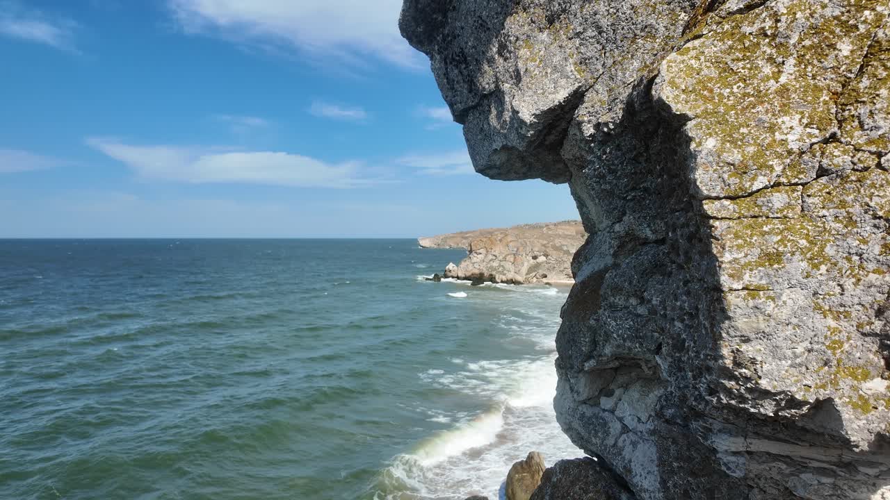 Stunning coastal views of Crimea along the Sea of Azov, showcasing rocky cliffs and gentle waves under a clear blue sky