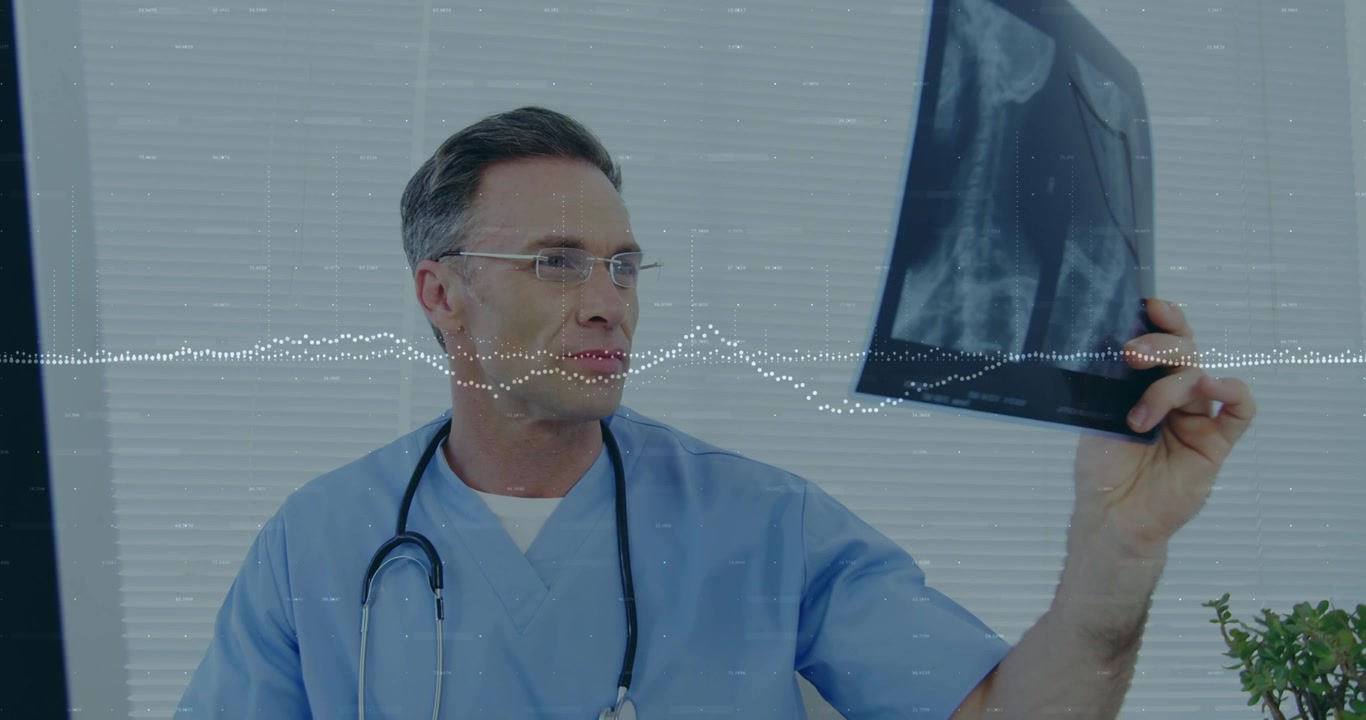 Clinician viewing monitor, lifting and rotating X-ray to diagnose while waveform overlaying film