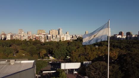 A-dynamic-aerial-footage-of-a-raised-Argentinian-flag-while-waving-on-a-windy-day