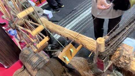 traditional art of weaving with spinning wheel make wool goat hair textile fiber cashmere wooden antique handmade craft culture domestic equipment thread tool village vintage yarn workshop woman