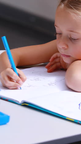 disabled schoolgirl studying in classroom