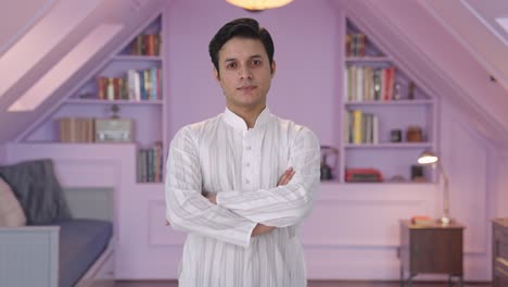 confident indian man standing crossed hands