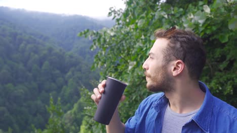 young man in the forest watching nature scenery.