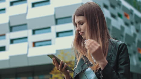 Woman listening to music on her phone in the city