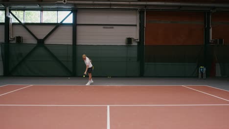 man playing indoor tennis