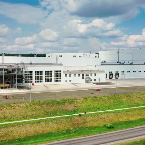 exterior of a factory industrial zone. warehouses, garages outside near the road. factories complex with modern buildings among nature