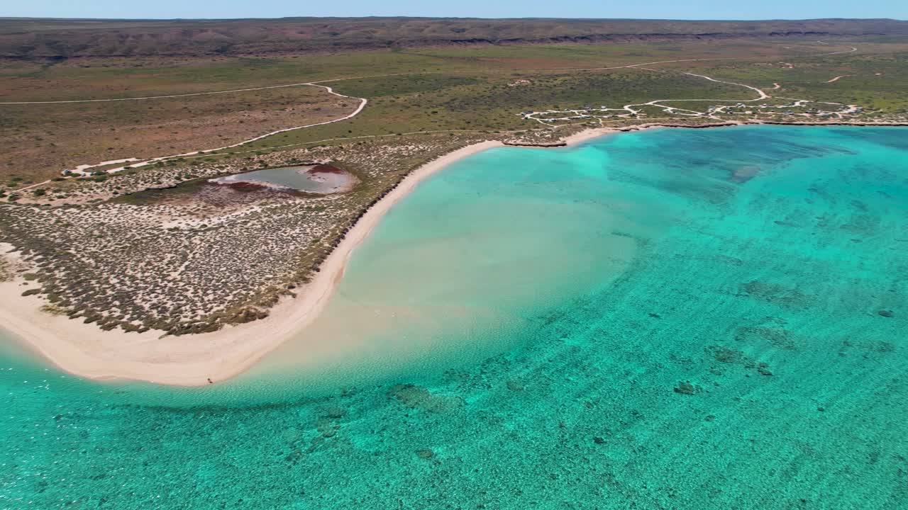 Aerial views of a tropical coastline with turquoise water
