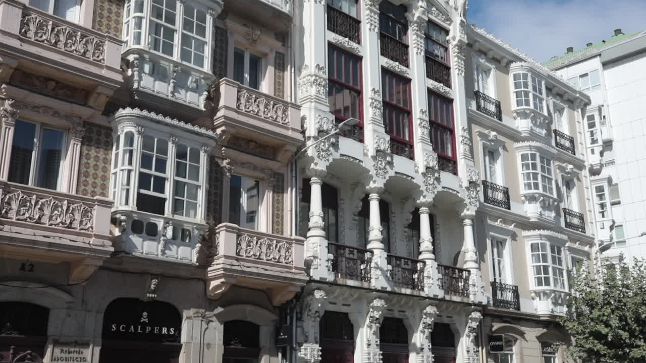 Ornate European building with intricate balconies and large windows under a bright sky
