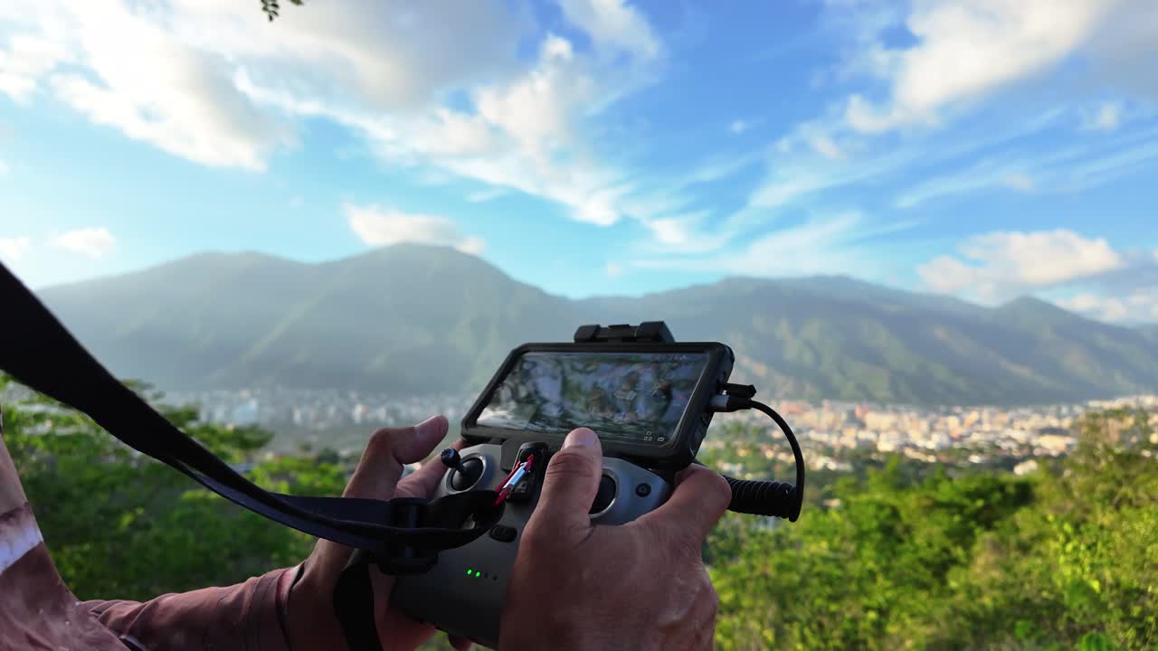 Technology and Travel: A Man Flying a Drone over the Caracas Cityscape