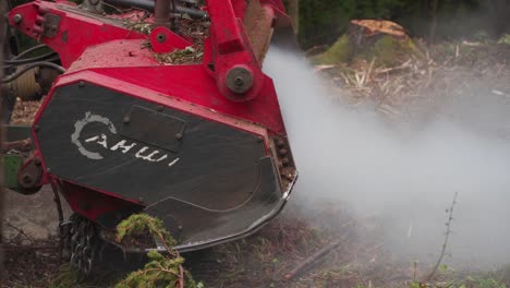 forestry mulcher processes tree trunks and generates steam in the process