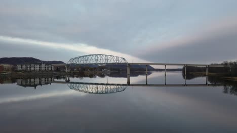 peaceful bridge reflection over a river at dawn/dusk