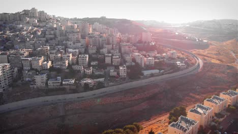 aerial view of urban landscape divided by a wall in the middle east