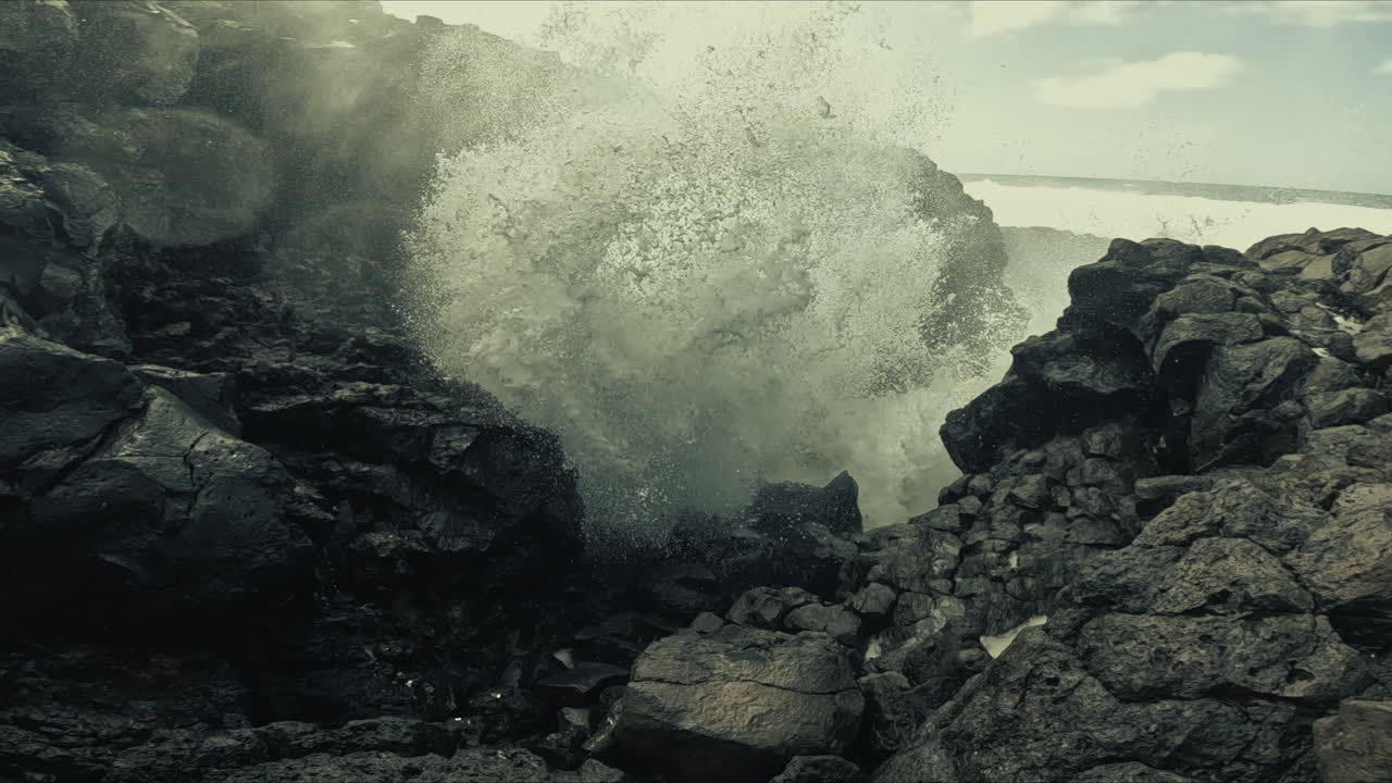 Powerful waves crashing against volcanic rock formations