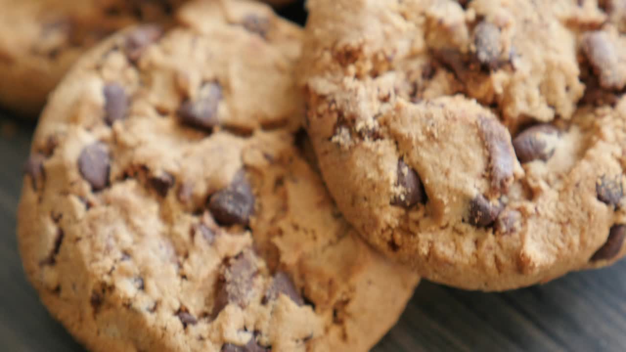 Chip cake cookies on the wooden table slow tilting 4K 3840X2160 UltraHD footage - Slow tilt of chocolate cookies on wooden surface 4K 2160p UHD video