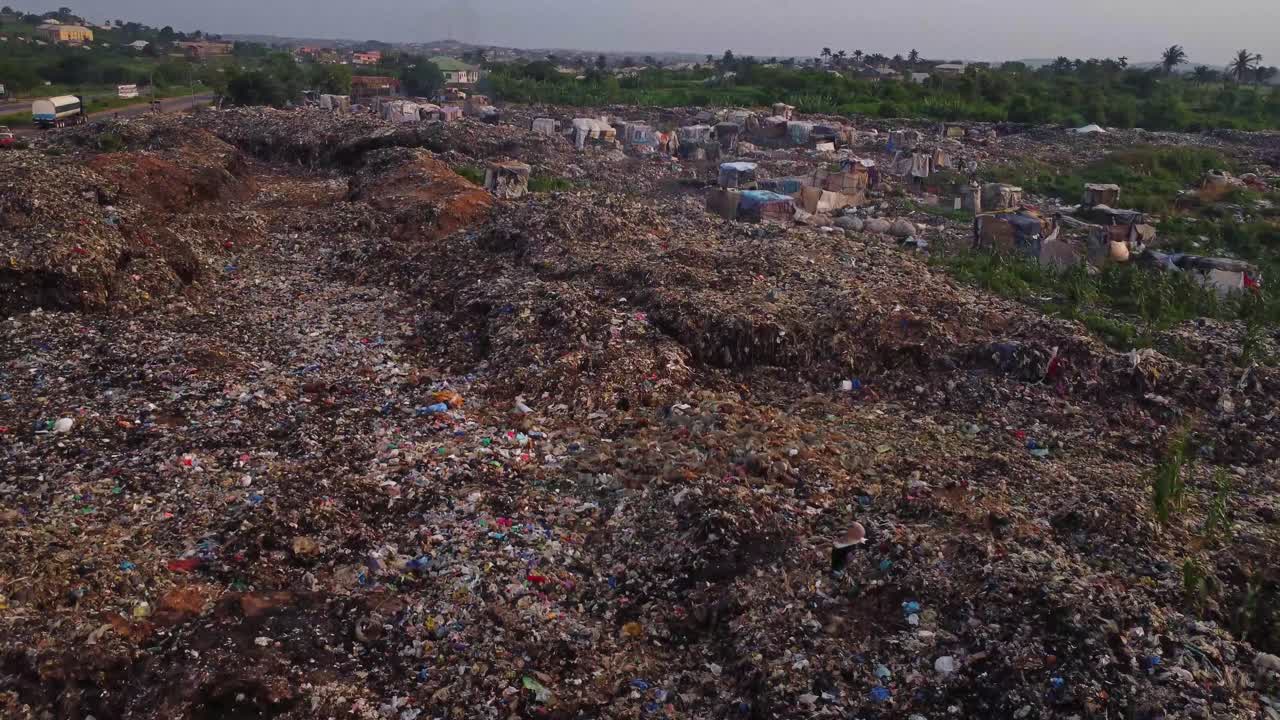 Aerial of vast landfill with birds flying around the garbage in Nigeria, Africa