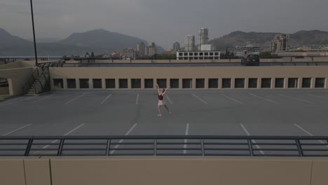 ballet dancer alone on a roof from a drone