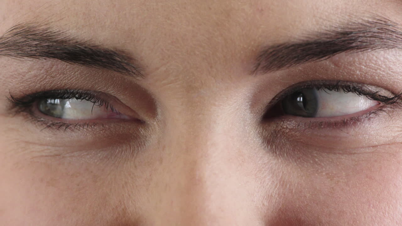 cerca de la mujer ojos azules mirando confundido expresión feliz usando maquillaje máscara cosméticos belleza femenina