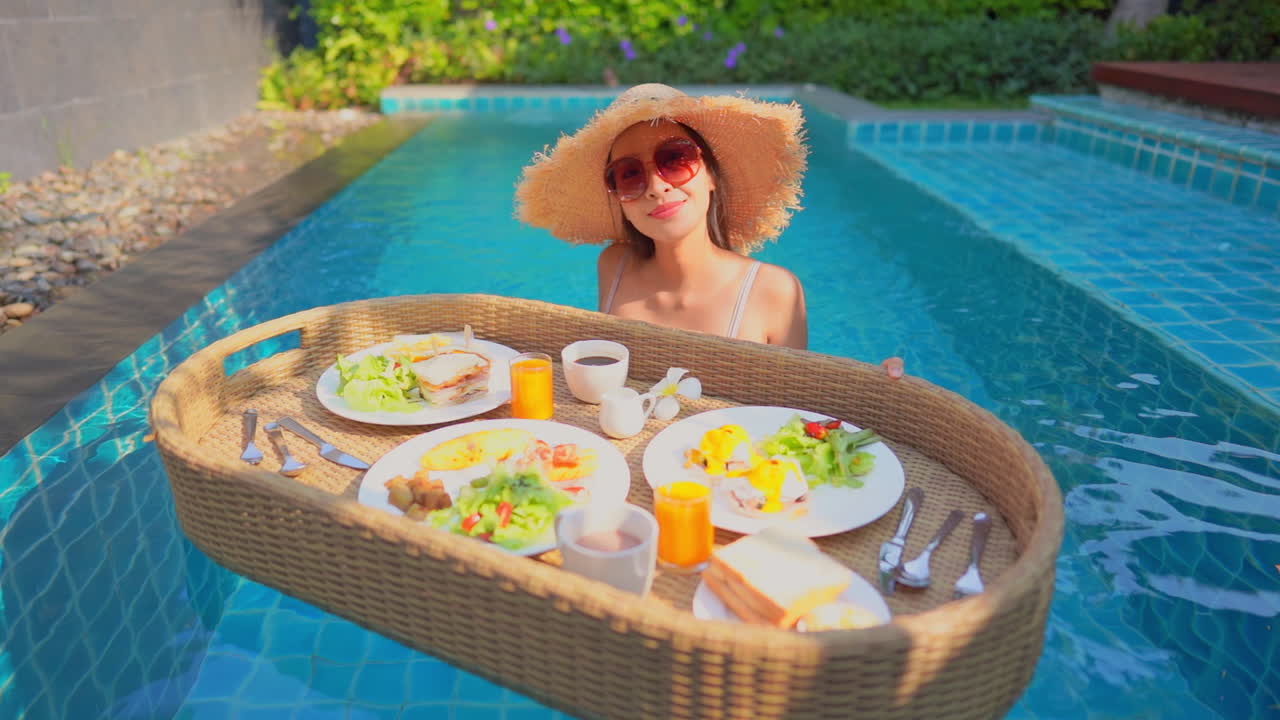 Breakfast is served on a floating table in a resort pool
