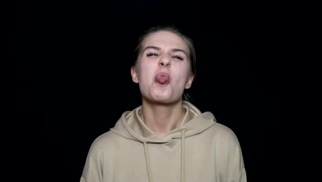 woman with neutral expression wearing a hoodie