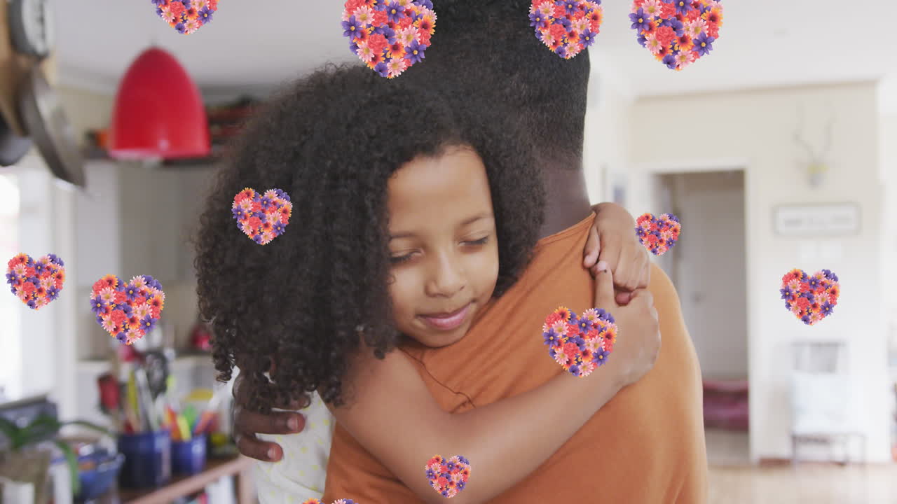 Animación de corazones de flores sobre padre e hija afroamericanos abrazándose en casa