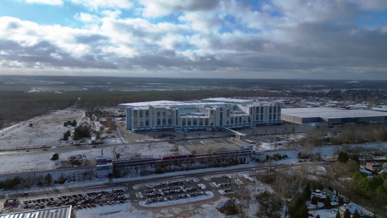 train traveling through a snowy cityscape in segefeld Falkensee. Tremendous aerial view flight wide orbit overview drone