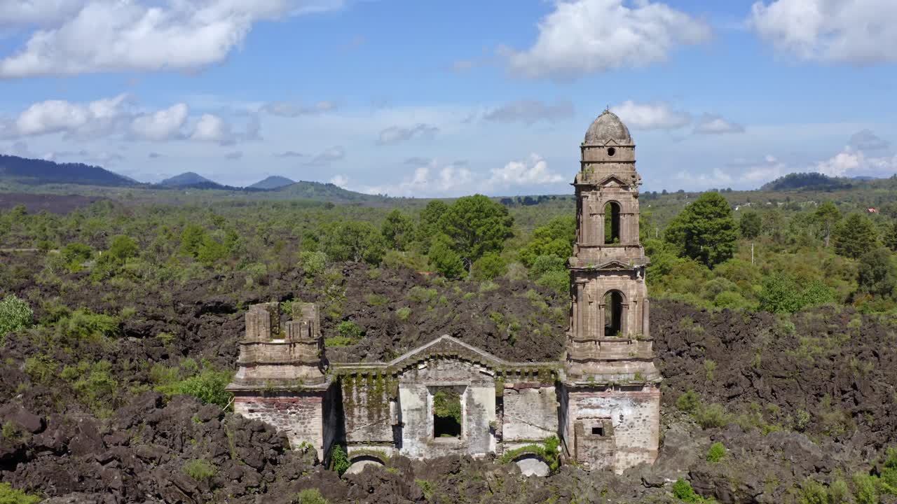 Smooth dolly shot moves backwards, revealing the ruins of the Church of San Juan Parangaricutiro